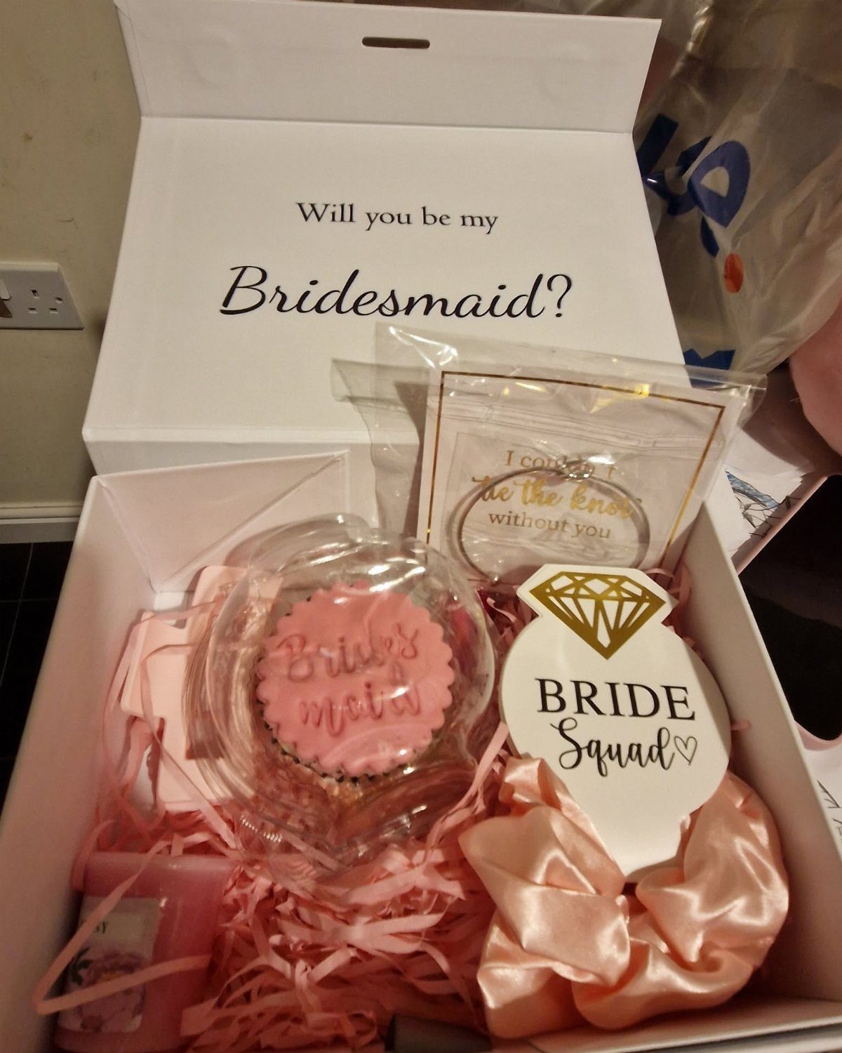 Bridesmaid proposal gift box with pink treats, a scrunchie, and a themed ornament.