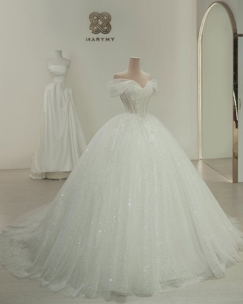 Sparkling white princess wedding gown with a full skirt on a mannequin