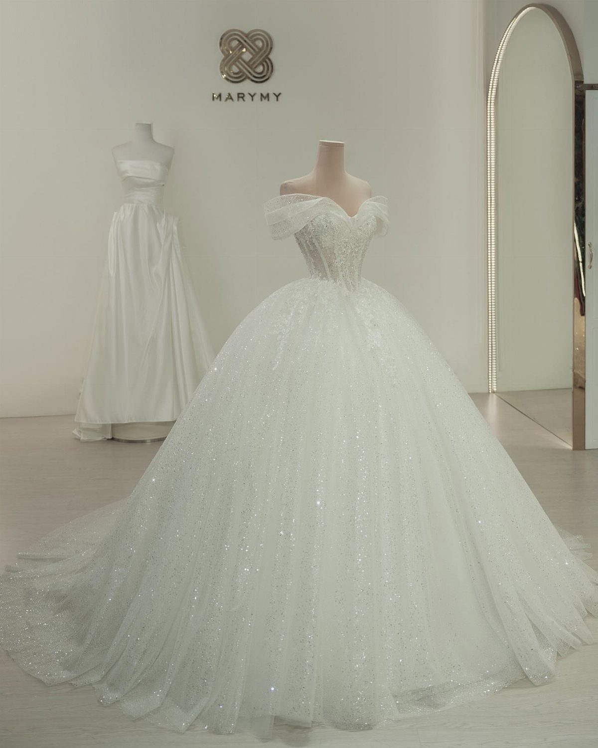 Sparkling white princess wedding gown with a full skirt on a mannequin